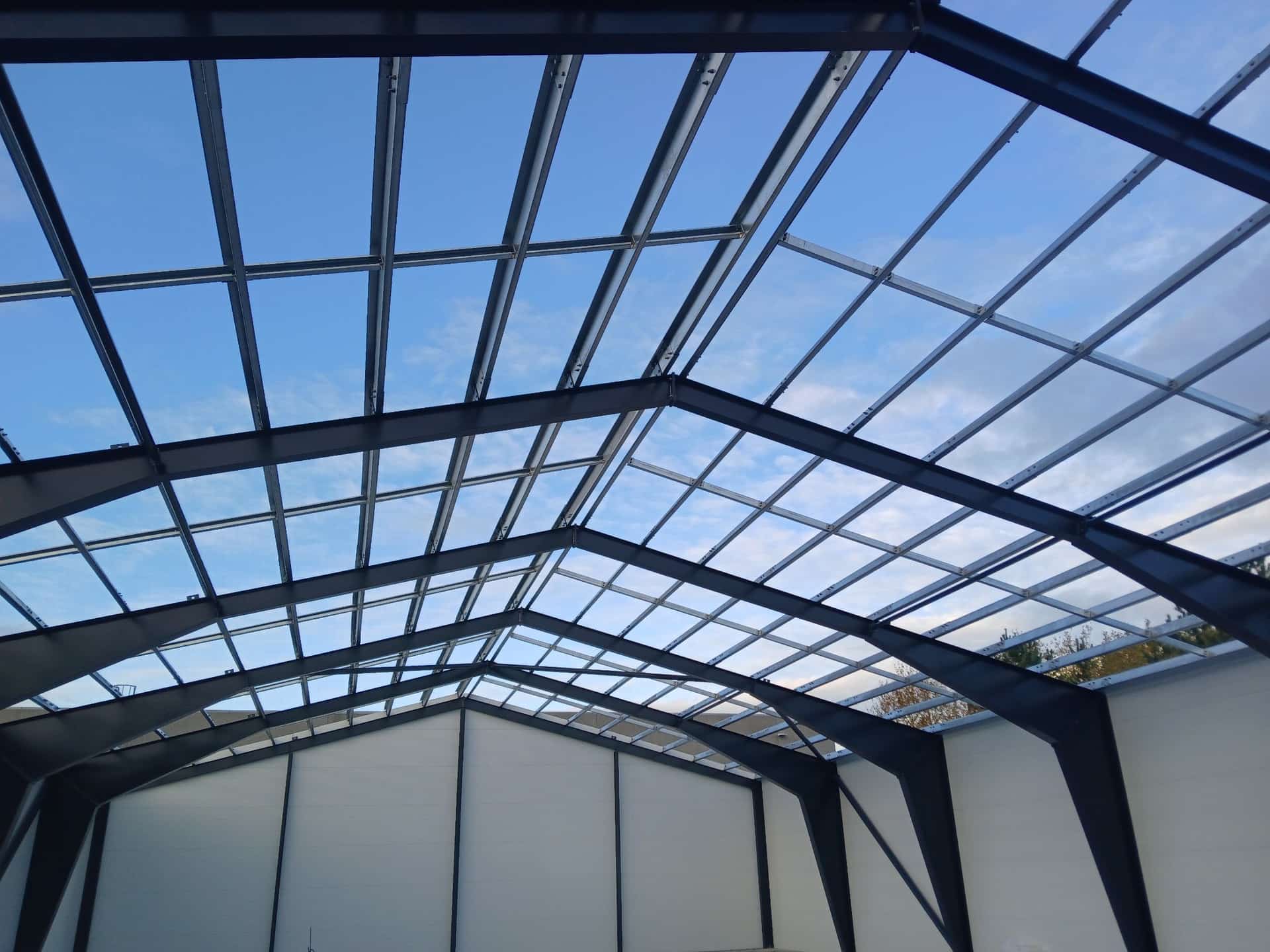 Galvanised roof purlins over the steel portal frames, seen from inside